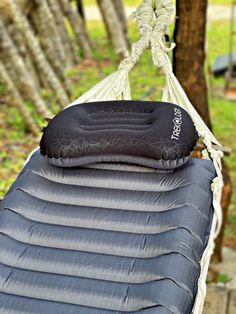 an inflatable hammock hanging from a tree