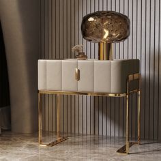 a table with a gold lamp on it and a white chair in front of it