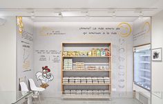 the interior of a grocery store with food items on shelves and drawings on the wall