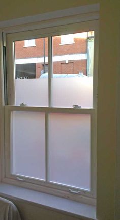 an open window with frosted glass on the outside and in between it's sides