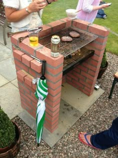 two people are cooking food on an outdoor grill