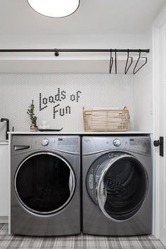 a washer and dryer in a laundry room with the words loads of fun written on the wall