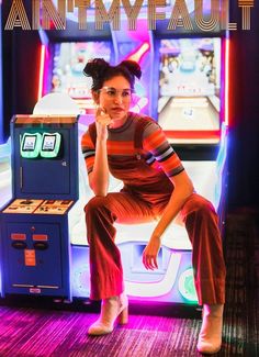 a woman sitting in front of a video game machine