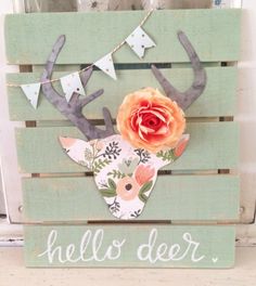 a wooden pallet with a deer head and flowers on it that says hello deer