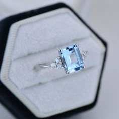 The default design option features 9x7mm Emerald Cut Aquamarine Blue, VVS1-Clarity, VG-Cut, Ex-Polish, VG-Symmetry set With D-Colorless Moissanite in 14K White Gold Engagement Ring. Model 709-9x7mm Also you can fully customize and engrave this ring by clicking the button "Personalize in 3D". As well please remember it takes up to 19-21 days to make and ship this item. Emerald Cut Aquamarine Engagement Ring, Engagement Ring Blue Stone, Senior Rings, Aquamarine Engagement Ring White Gold, Emerald Cut Aquamarine Ring, Aquamarine Wedding Ring, Aquamarine Solitaire Ring, Wedding Rings Emerald Cut, Wedding Studs