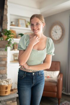 Make your mark with this Smocked & Smitten Over You Top! The sage-hued cotton gives you a winning combination of comfort and style, while the bubble cap sleeves add a touch of fun. Get ready to fall head over heels for this top - it's true-to-size and sure to turn heads! Trendy Smocked Back Short Sleeve Top, Trendy Green Smocked Top, Casual Green Smocked Top With Puff Sleeves, Casual Cotton Smocked Top With Short Sleeves, Green Smocked Top With Short Sleeves For Summer, Green Smocked Top With Short Sleeves, Trendy Cotton Smocked Back Top, Trendy Cotton Smocked Top With Smocked Back, Stretch Smocked Top With Short Sleeves