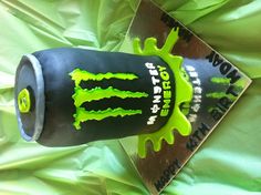 a birthday cake made to look like a monster can with neon green icing on it