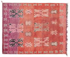 an old rug with different colors and designs on the front, including pinks, purples, and browns