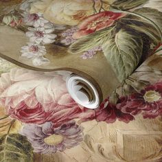 a close up of a wallpaper with flowers and leaves on the surface, as well as a roll of tape