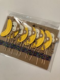 monkey and banana shaped cupcake toppers on sticks in cellophane package with ribbon