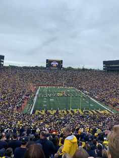 a football stadium filled with people watching the game