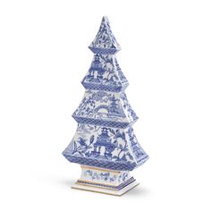 a blue and white porcelain christmas tree with people on the top, in front of a white background