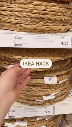 someone is holding up a sticker that says ikea hack in front of some baskets