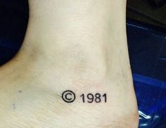 a small tattoo on the foot of a person