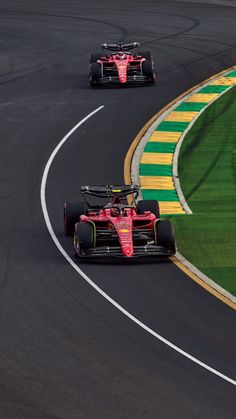 three racing cars driving on a race track