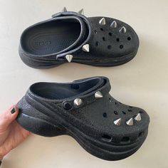 Brand: Crocs Size: Womens 7 Condition: Very Good Preowned Condition. Very Minor Wear On Bottom Soles. Great Tread And Clean. Colors: Black With Silver Studs Description: Womens Crocs Classic Bae Glitter Stud Clog Black | Crocs Platforms The Classic Clog Has Been Reimagined With An Extra Dose Of Height, Attitude, And Edge. Introducing The Crocs Classic Bae, Featuring An Ultra-Contoured Outsole That Supports The Upper You Know And Love But There’s More. This Iteration Features Glitter From Top To Bottom And Punk Studs To Add The Edge The Bae Deserves. When You’re Feeling A Little Extra, Flaunt It Fearlessly In The Crocs Classic Bae Glitter Studs Clog. Details: All-Over Glitter Trea Goth Crocs, Crocs Platforms, Bae Clog, Punk Studs, Womens Crocs, Studded Clogs, Black Crocs, Women's Crocs, Crocs Shoes