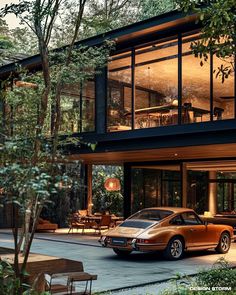 an orange car is parked in front of a large house with glass walls and floor to ceiling windows