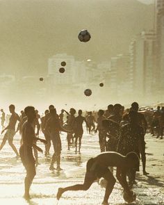 many people are playing in the water at the beach