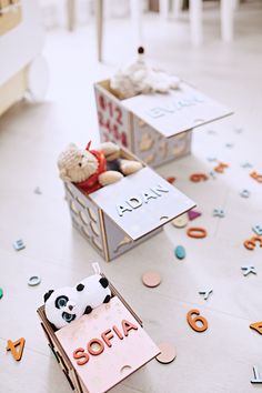 two small boxes filled with stuffed animals on top of a floor covered in confetti