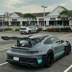 a grey sports car parked in a parking lot