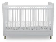 a white crib with no mattress in the front and side rails on each side