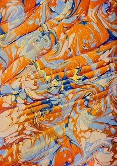 an orange, blue and white painting with swirls on it's surface is shown