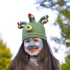 Whimsical Halloween Party Hat with Colorful Antennae 👻🎉 Elevate your Halloween attire with our charming party hat! This green hat features a flurry of playful antennae, each adorned with a different colored eyeball for a dash of whimsy. Perfect for Halloween celebrations, you'll be the star of the show! Key Features: Festive Design: Get into the Halloween spirit with this vibrant green hat and its eye-catching eyeball antennae. Customizable Fit: The hat has a circumference of approximately 20.5 inches. If it doesn't quite fit, don't worry - just contact us for a custom size. Durable and Easy to Clean: Made to withstand the festivities and easy to clean if it gets a little spooky. Ideal Gift: This hat makes for a fantastic holiday gift and is a must-have for Halloween. Transform your Hall Novelty Halloween Costume Cap, Halloween Cosplay Beanie Hat, Playful Winter Costume Hats And Headpieces, Adjustable Themed Green Hat, Adjustable Green Themed Hat, Fun Green Crochet Hat For Winter, Green Fun Crochet Hat For Winter, Playful Costume Hats And Headpieces For Halloween Cosplay, Fun Costume Hats And Headpieces