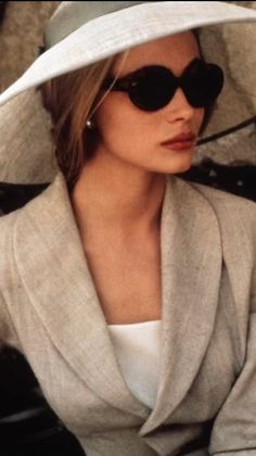 a woman wearing a white hat and sunglasses