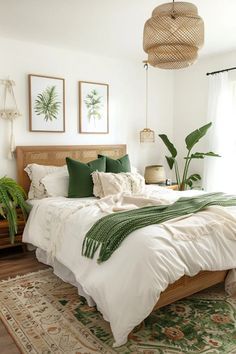 a bed with white sheets and green pillows in a bedroom next to a large window