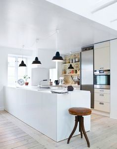 a kitchen with an island and stools in it