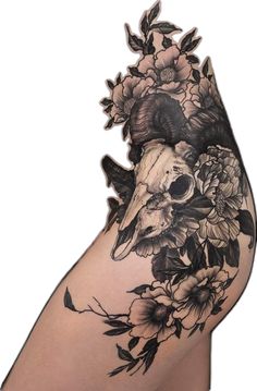 a woman's arm with flowers and skulls on it