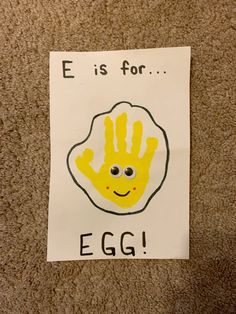 a hand print with the words e is for egg on it and a smiley face