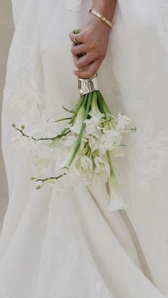 a person in a wedding dress holding a bouquet