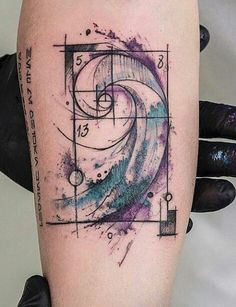 an artistic tattoo on the leg of a woman's arm with a geometric design