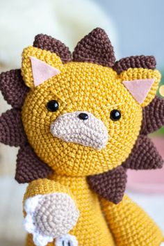 a crocheted yellow and brown stuffed animal