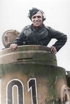 an old man is sitting on top of a tank