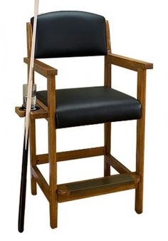 a wooden chair with a black leather seat and baseball bat on it's arm