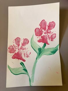 a piece of paper with some flowers painted on it