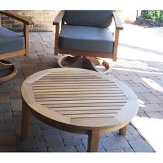 two chairs and a table on a brick patio