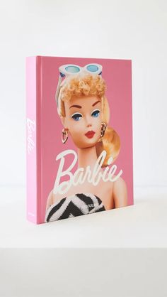 a pink book with a barbie doll on it's cover and the words barbie written in large letters