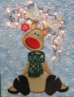 a christmas card with a reindeer wearing a green scarf and lights in the background,