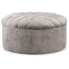 a round ottoman that is made out of grey fabric and has buttons on the top