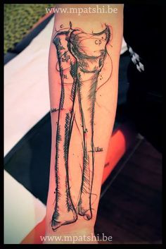 a person with a tattoo on their arm that has an image of a woman's leg