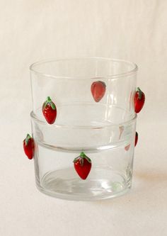 three glass bowls with strawberries in them