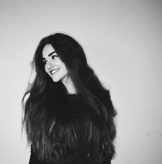 a black and white photo of a woman with long hair