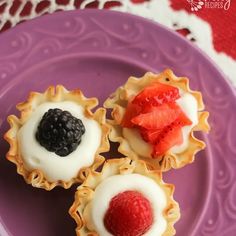 three small desserts on a purple plate