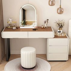 a white desk with a mirror, stool and other items on it in a room