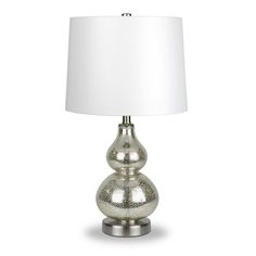 a silver lamp with a white shade on it