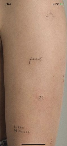 the back of a woman's thigh with tattoos on it and words written in cursive writing