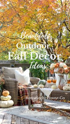 A furnished outdoor patio is decorated for autumn with cozy fall textiles and a fall floral arrangement on an outdoor coffee table. Colorful fall foliage is in the background. Porch Bench Fall Decor, Autumn Mums Front Porches, Benches Decorated For Fall, Fall 2023 Front Porch, Fall Back Patio Decor, Fall Decor Backporch, Fall Back Porch Ideas, Outdoor Table Fall Decor, Back Porch Fall Decor